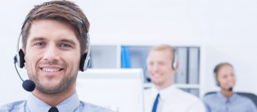 Guy in call center with head set in place