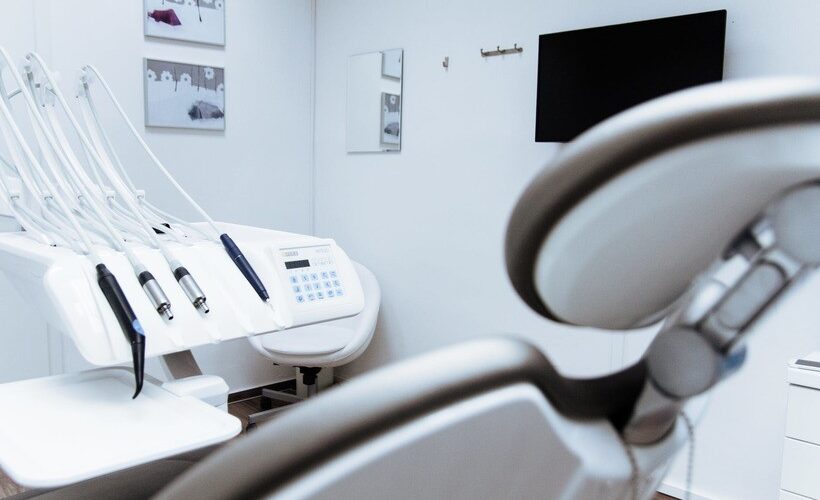 Shot from behind the left side of a dentists chair looking at the oral instruments
