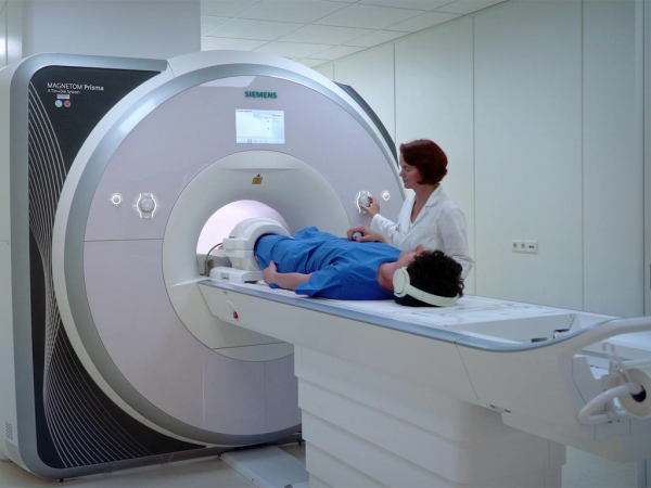 Doctor placing patient in a MRI machine for diagnostic testing